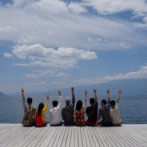 Social Wellness Example: Group of Friends Sitting on a Dock together